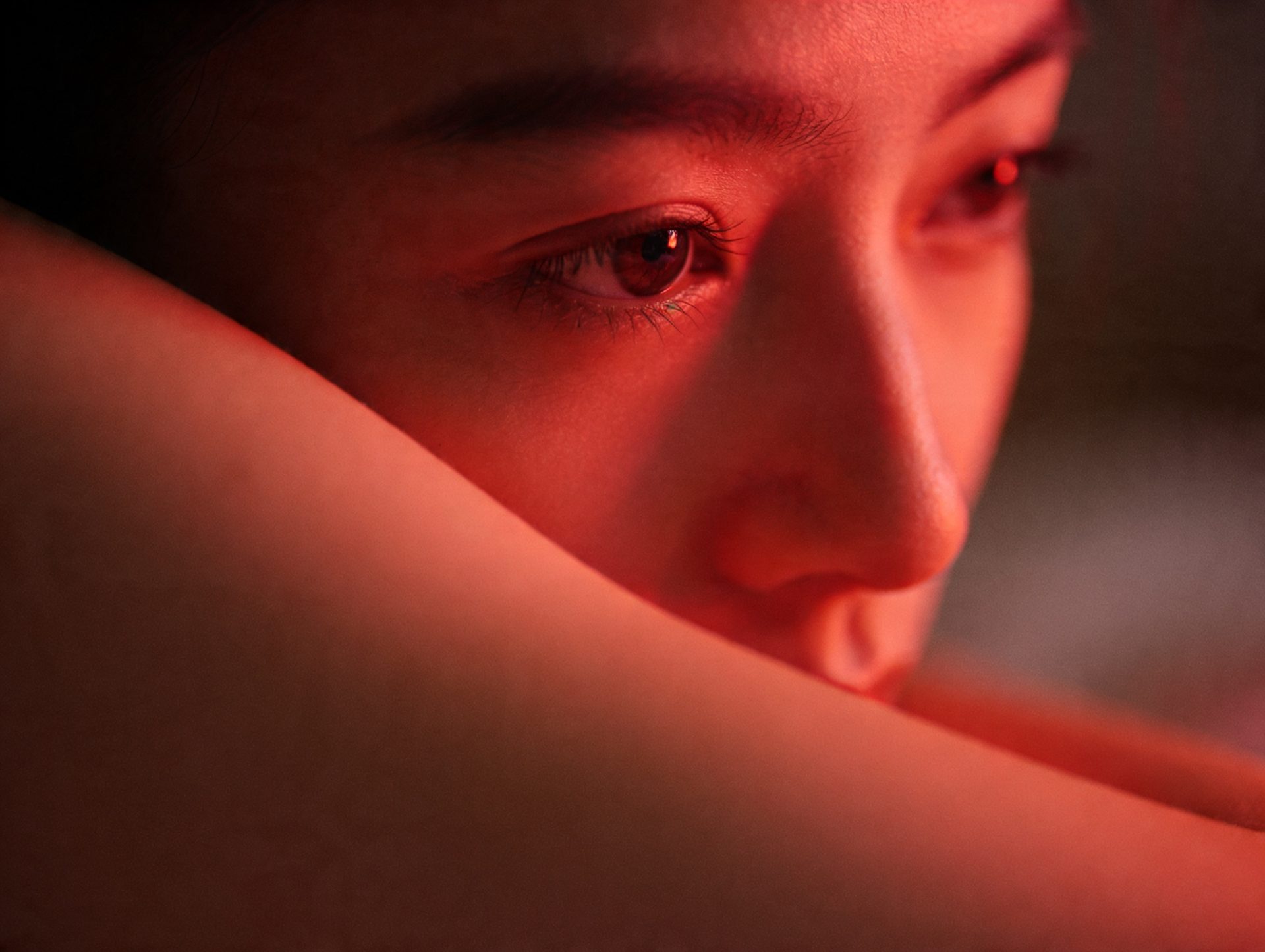 Close up portrait bathed in warm red light